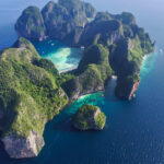 Andaman Coast
Top view of isolated rocky tropical island with turquoise water and white beach. Aerial view of Phi-Phi Leh island with Maya Bay and Pileh Lagoon. Krabi province, Thailand.